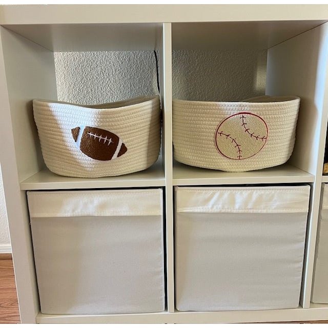 Natural colored cotton rope baseball basket with handle slits.&nbsp; Base is 12" x 9".&nbsp; Top is approximately 15" x 12". 7" in height.&nbsp; Great for holding anything and everything. An adorable addition to every nursery.&nbsp;